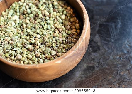 Thyme in a wooden bowl on a blak table