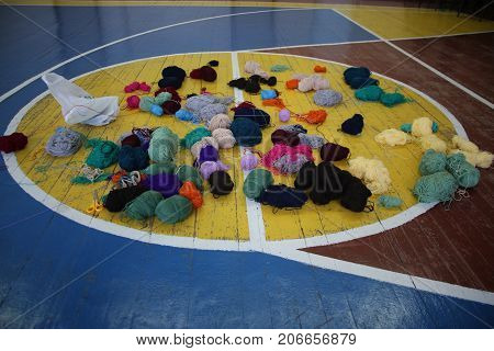 Multicolored balls of yarn on the basketball field