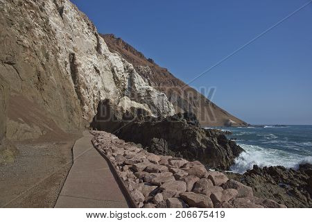 Anzota Caves at Arica on the coast of Chile. The area was used as a settlement by the Chinchorro people and later mined for guano deposited on the cliffs.