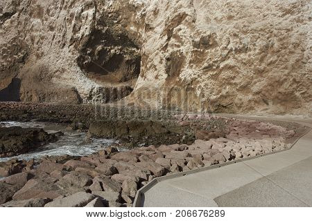 Anzota Caves at Arica on the coast of Chile. The area was used as a settlement by the Chinchorro people and later mined for guano deposited on the cliffs.