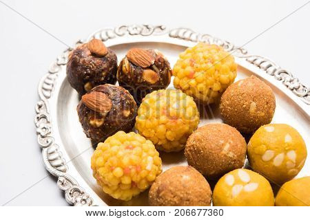 Stock photo of variety of sweet laddu or laddoo or ladu, a sweet dumpling made up of bundi, dry fruits or rava, selective focus