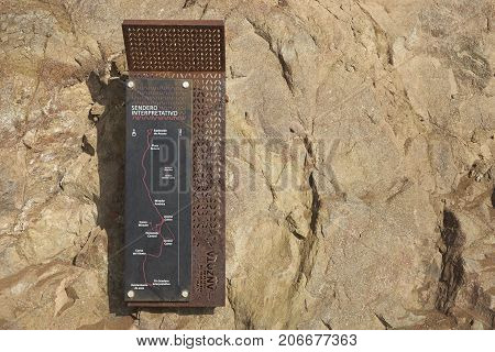 Anzota Caves, Arica, Chile - August 25, 2017: Sign at the entrance to Anzota Caves. The area was used as a settlement by the Chinchorro people and later mined for guano deposited on the cliffs.