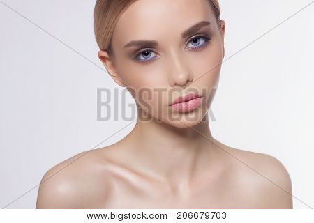 Portrait of a charm of model of the beauty with new daily cosmetics and the romantic taken-away bunch of hair. Fashion a solar marker on leather sexual cosmetics of lips of gloss and dark eyebrows