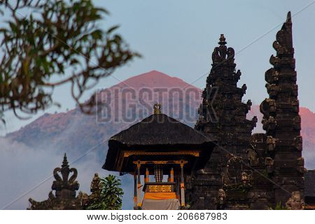 Balinese Sacred Mountain Agung Colored In Pink By Sunset Light. Main Bali Temple Pura Besakih At The