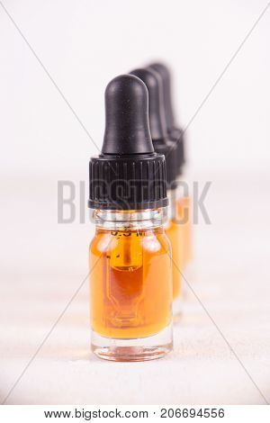 Macro detail of dropper with CBD oil, cannabis live resin extraction isolated on white - medical marijuana concept