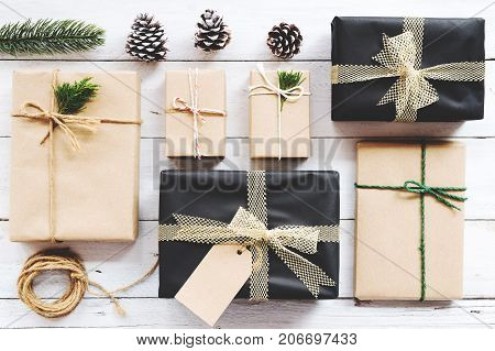 Christmas background with handmade present gift boxes and rustic decoration on white wooden board. Creative Flat layout and top view composition with border and copy space design.