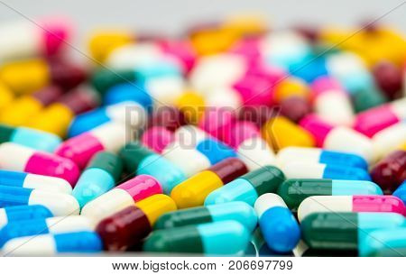 Selective focus of antibiotic capsules pills on blur background drug resistance concept.