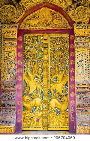 Bas-relief On The Wall Of The Temple Wat Sensoukaram In Louangphabang, Laos. Vertical. Close-up.