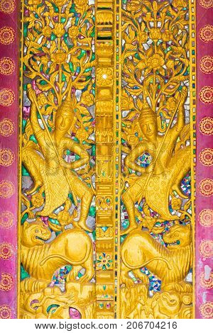 Bas-relief On The Wall Of The Temple Wat Sensoukaram In Louangphabang, Laos. Vertical. Close-up.
