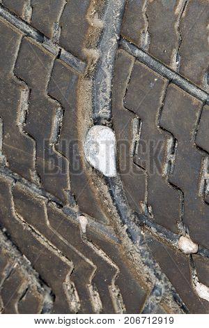 stone in the tire wheel . Photo of abstract background