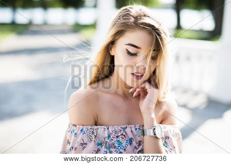Close-up Portrait Of Young Blonde Womanstanding In The Street. Beautiful Girl In Urban Background.