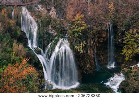 Croatia. Plitvice Lakes. A cascade of waterfalls surrounded by autumn forest.