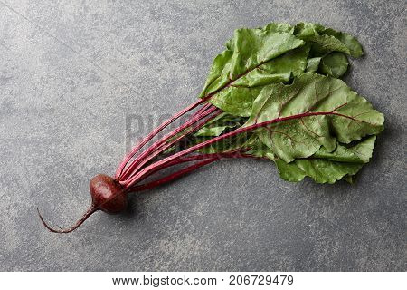 Fresh harvested beetroot on stone background, top view