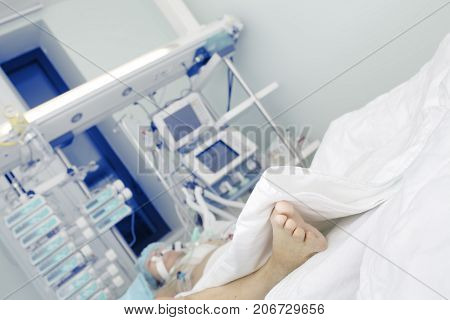 Patient in serious condition in intensive care unit.