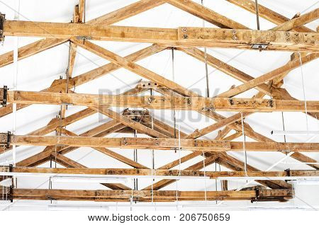 Wooden Roof Structure In White Bright Interior. Old Rafters In The Loft Interior
