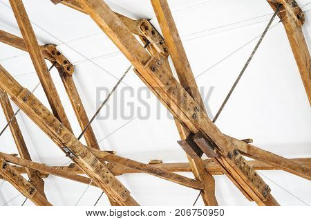 Wooden Roof Structure in White Bright Interior. Old Rafters in the Loft Interior