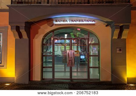 SIBIU ROMANIA SEPTEMBER 22 2017: Logo of Banca Transilvania (Bank of Transylvania) at night on a Sibiu office of the company. BT is considered to be one of the main local bank in the region
