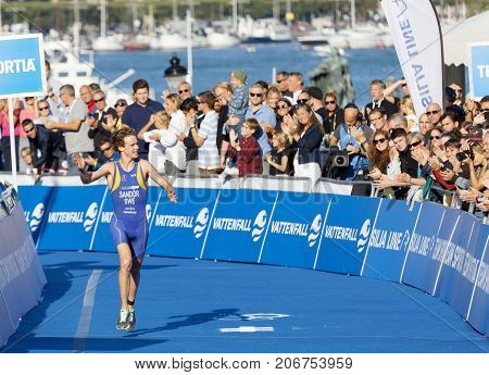 STOCKHOLM - AUG 26 2017: Running triathlete Gabriel Sandor (SWE) close to the finish line audience in the background in the Men's ITU World Triathlon series event August 26 2017 in Stockholm Sweden