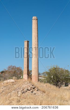 KARIBIB NAMIBIA - JULY 3 2017: Two historic smokestacks or chimneys in Karibib a small town in the Erongo Region of Namibia.