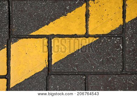 Yellow color line paint on conrete block background