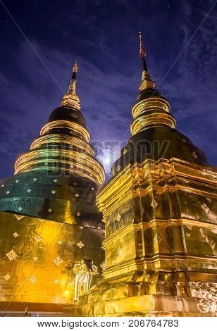The golden pagodas shines in the moonlight