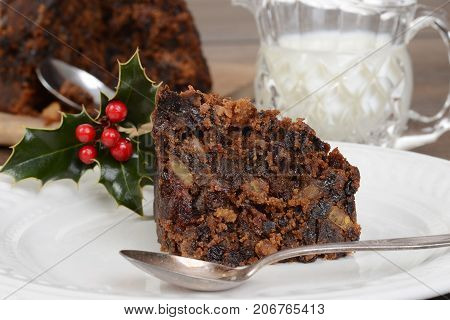 closeup christmas pudding with spoon and cream