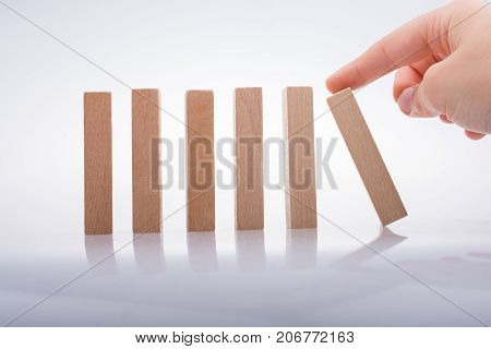 Hand Holding Wooden Domino