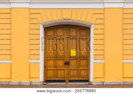 The wooden door in the wall of National Pushkin Museum front view St. Petersburg Russia