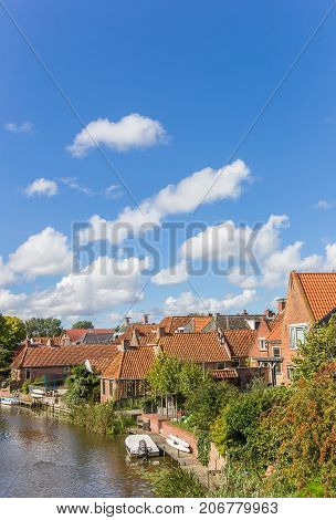 Old houses and river in the village of Winsum Netherlands