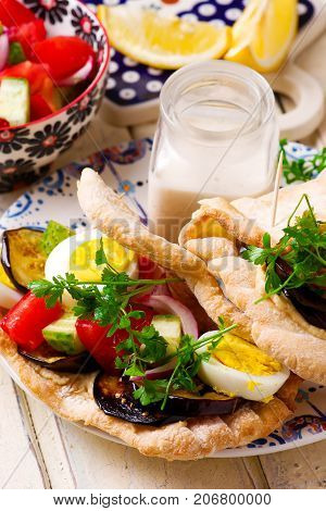 pita sabich sandwich with hummus and vegetables..selective focus