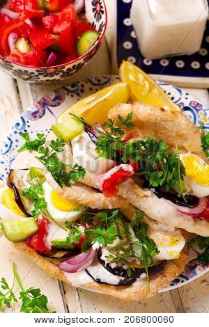 pita sabich sandwich with hummus and vegetables..selective focus