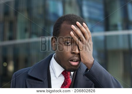 Close Up Portrait Of African American Businessman With Face Palm Gesture. Disappointed Stressed Out