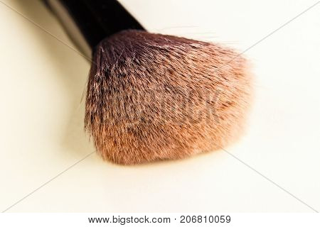 A large brush for powder application. Close-up. Accessory for make-up. The make-up tool
