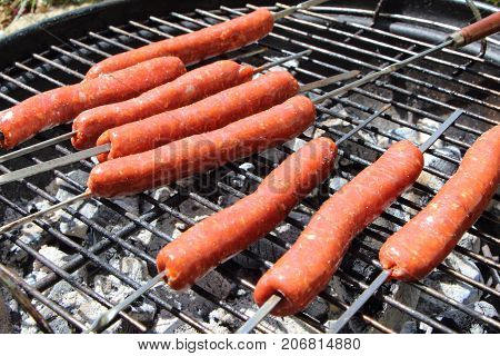 Merguez on the rack of a barbecue