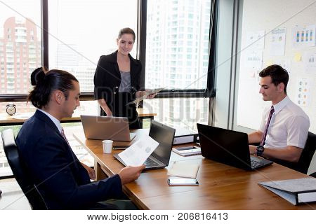 Businesswoman Presentation To A Group In Meeting.