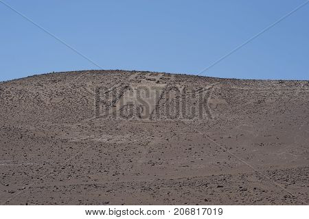 Giant of the Atacama. Large petroglyph on a rocky outcrop in the Atacama Desert in the Tarapaca Region of northern Chile.