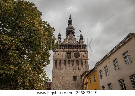 Sighisoara Clock Tower (Turnul cu Ceas) during a cloudy fall afternoon. It is the main entrance of Sighisoara castle in Romania birthplace of Vlad Tepes aka Dracula