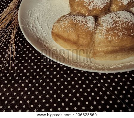 Still life of homemade baking wheat spikes on a table.