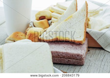 Many Breads And Coffee Cups On Wooden Floor.