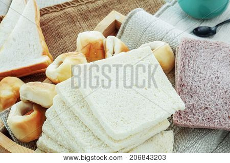 Many Breads On The Tray And Cup Of Coffee.