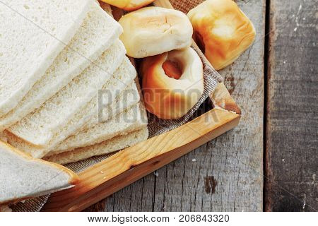 Many Of Breads On A Wooden Tray.