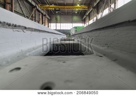 A gray, massive frame of a metal-cutting machine. Shop assembly of metalworking machines.