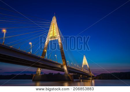 Budapest Hungary - The illuminated Megyeri Bridge over river Danube at blue hour with colorful clear sky