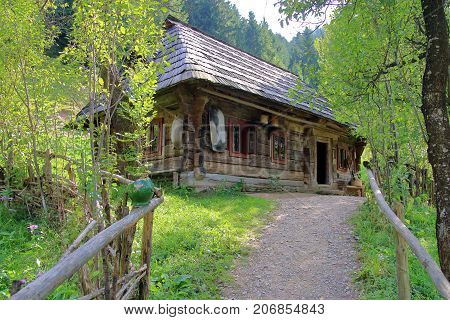 The picture was taken in Ukraine in Kolochava village. In the photo a very old village house built of logs.
