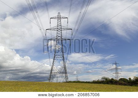 Electricity pylons crossing the Welsh countryside with dramatic skies