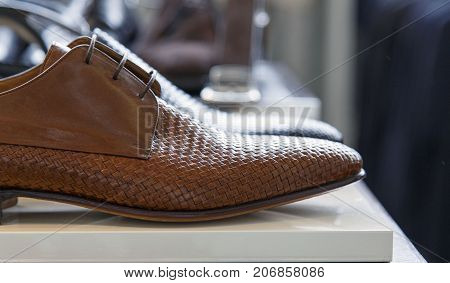 Expensive pair of men's brouge shoes at a duty free shop at an airport.