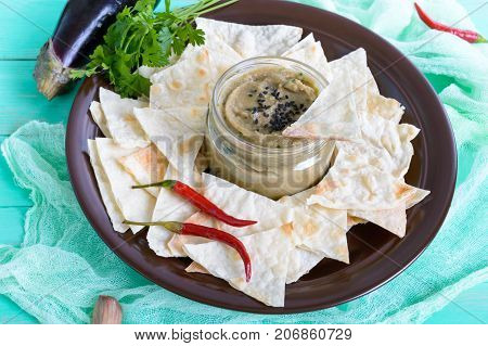 Light dietary pate from eggplant. Baba ganush is an Asian dish. Serve with thin lavash on a ceramic bowl.
