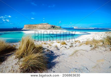 Amazing view of Balos Lagoon with magical turquoise waters, lagoons, tropical beaches of pure white sand and Gramvousa island on Crete, Greece