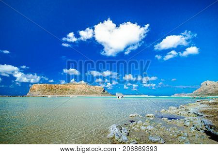 Amazing view of Balos Lagoon with magical turquoise waters, lagoons, tropical beaches of pure white sand and Gramvousa island on Crete, Greece