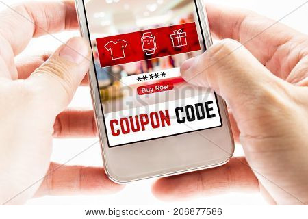 Close Up Two Hand Holding Mobile Phone With Coupon Code Word And Blurred Store Background, Digital M
